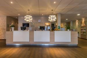 a lobby with white signs on a counter at Good Morning+ Nyköping in Nyköping