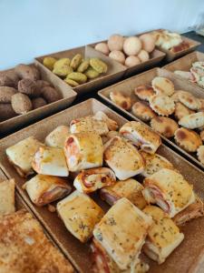 a bunch of different types of pastries and eggs at Pousada Aliança in Pirenópolis