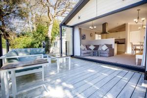 an open patio with a couch and a table at Flip Flops in Christchurch