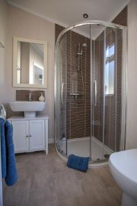 a bathroom with a shower and a sink at Flip Flops in Christchurch