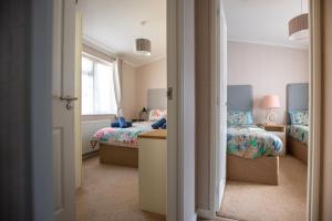 a bedroom with two beds and a window at Flip Flops in Christchurch