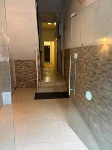 a hallway in a building with a glass door at Stylish Garden Apt 2 Min Beach in Tel Aviv