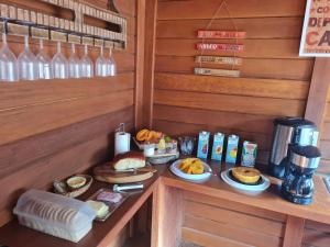 a breakfast room with a table with food and drinks at Pousada Recanto Viva a Vida in Domingos Martins