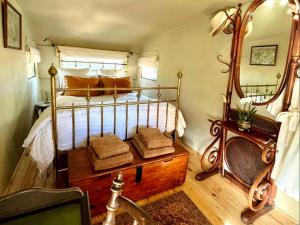 a bedroom with a bed and a wooden floor at Tula Retreat in Calitzdorp