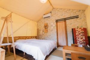 a bedroom with a bed and a desk and a ladder at ウッドデザインパーク瀬戸 in Seto