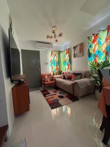a living room with a couch and a table at Norene Bianca Staycation in Carmona