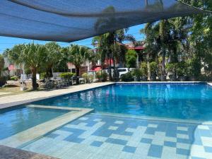 a large swimming pool with blue water at Norene Bianca Staycation in Carmona