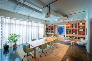 a dining room with a wooden table and chairs at Shada Hotel Dubai - فندق شدا دبي in Dubai