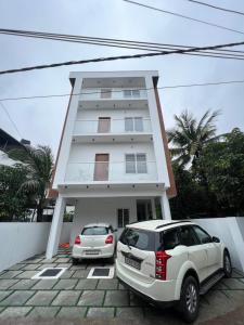 a white car parked in front of a building at Hotel Eleven Space Kochi in Cochin