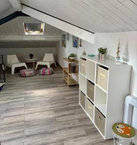 a living room with a white cabinet and a table at Brezza Marina in Diano Marina