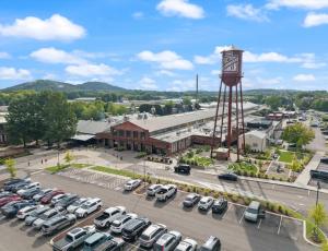 a parking lot with a water tower and cars parked at Carters Court Serene Suite in Franklin