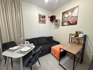 a living room with a couch and a table at Belstay in Ras al Khaimah