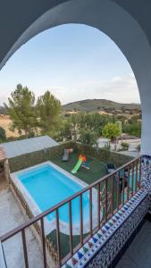 a view of a swimming pool from a balcony at Los Tatos Alojamiento Rural in Mures