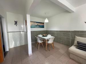 a dining room with a table and chairs and a couch at Isamar Playa in Órzola