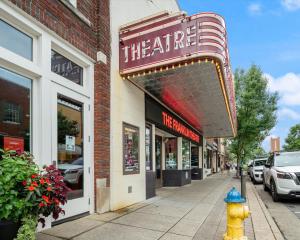 a fire hydrant sitting in front of a theater at Carters Court Grand Escape in Franklin +28 photos