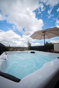 una grande piscina con un ombrellone sul tetto di Villa Bulle Dorée & Spa privatif Amnéville ad Amnéville