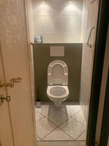 a bathroom with a white toilet in a stall at Appartement 2 chambres à Place Coronmeuse in Herstal +2 photos