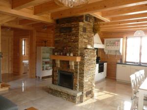 a large living room with a stone fireplace at Dom nad Popradem in Stary Sącz