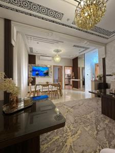 a living room with a table and a dining room at Chic & Cozy Apartment for a Comfortable Stay Fes in Fès