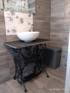 a bathroom with a bowl sink on a table at Streamside apartment in Jarkowice