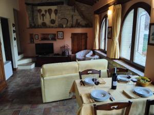 a living room with a table and a couch at Tre Archi in Cagli