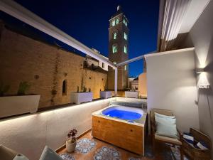 a hot tub on a balcony with a clock tower at Manna Blue Sky - Apulian Suites in Barletta