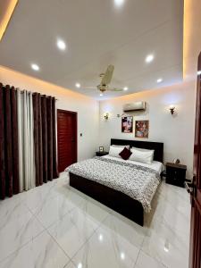 a bedroom with a large bed in a room at Bahria Town Karachi Full Furnished Guests Houses in Karachi