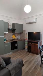 a living room with a couch and a kitchen at Tourist rental 35574 Orvieto in Orvieto