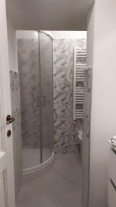 a bathroom with a shower with a glass door at Tourist rental 35574 Orvieto in Orvieto +24 photos