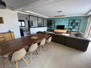 a living room with a couch and a table and chairs at Villa Nafissa in Diass