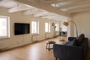 a living room with a couch and a flat screen tv at Alster Stay no 45 in Hamburg
