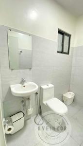 a bathroom with a toilet and a sink at Aveinzor Nest Studio in Dipolog