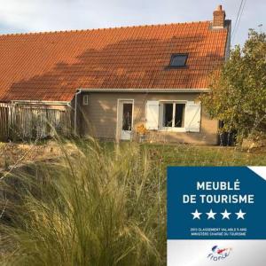 a house with a sign in front of it at Maison spacieuse avec jardin et feu de bois et parking gratuit pour 3 voiture in Le Crotoy