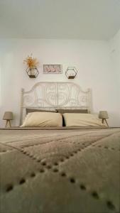 a bedroom with a large bed with two lamps on it at Nina apartment in Alexandroupoli