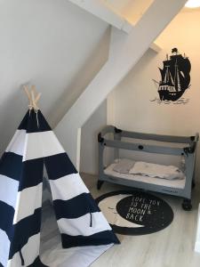 a childs room with a pirate tent and a bed at Maison spacieuse avec jardin et feu de bois et parking gratuit pour 3 voiture in Le Crotoy +27 photos