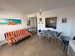 a living room with a couch and a table and chairs at Puerto de la Duquesa MINIMUM 3 NUITS in Manilva +13 photos