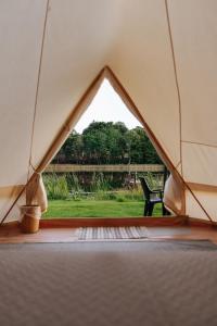 a tent with a view of a yard at Lakeside camping in Balninkai +9 photos
