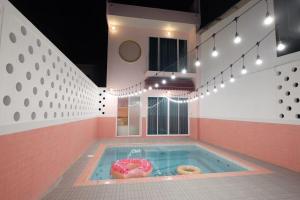 a jacuzzi tub with donuts in it at Babe Pool Villa Ranong in Ranong
