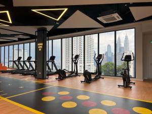 a gym with a view of a city skyline at MAJESTIC RESlDENCE KLCC in Kuala Lumpur