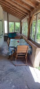 a patio with a table and a bench in a house at Logement entier chez Hélène in Sainte-Gemme-Martaillac