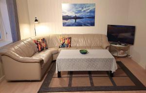 a living room with a couch and a coffee table at Fishermens House, 3 bedrooms apartment near the sea Medby Senja in Senja