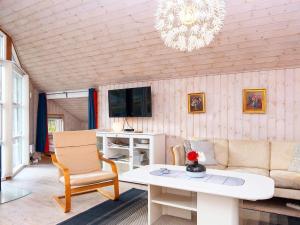 a living room with a couch and a table at holiday home in Fårvang