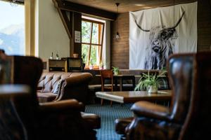 a living room with a large picture of a antelope on the wall at Mellow Mountain Hostel in Ehrwald