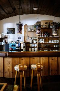 a bar with two stools in front of a counter at Mellow Mountain Hostel in Ehrwald