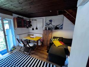 a living room with a table and a couch at White Rabbit Apartment in Spital am Semmering