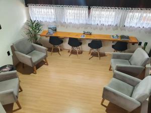 a room with a table and chairs and a desk at Dein Platz Pousada in Timbó
