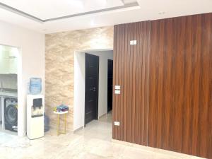 a large wooden door in a room with a wall at Mountain View I city, 6 October, Have fun in 6th Of October
