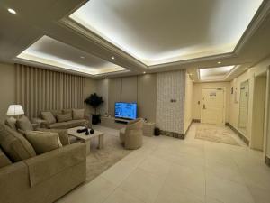 a large living room with couches and a tv at Alarjan Dream in Riyadh