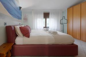 a bedroom with a large bed with red furniture at Casa dell'artista - Free Parking in Como