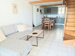a living room with a couch and a table at Casa ARTEN in Alzonne